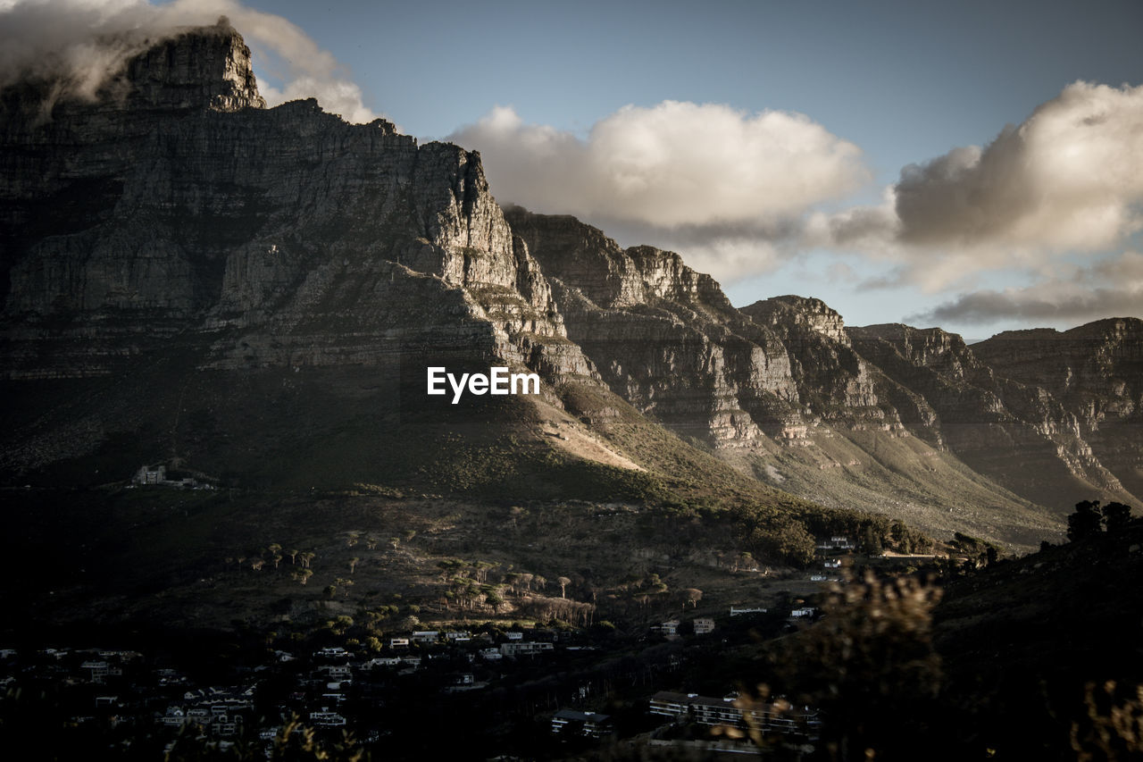 Scenic view of mountains against sky with a dramatic twist 