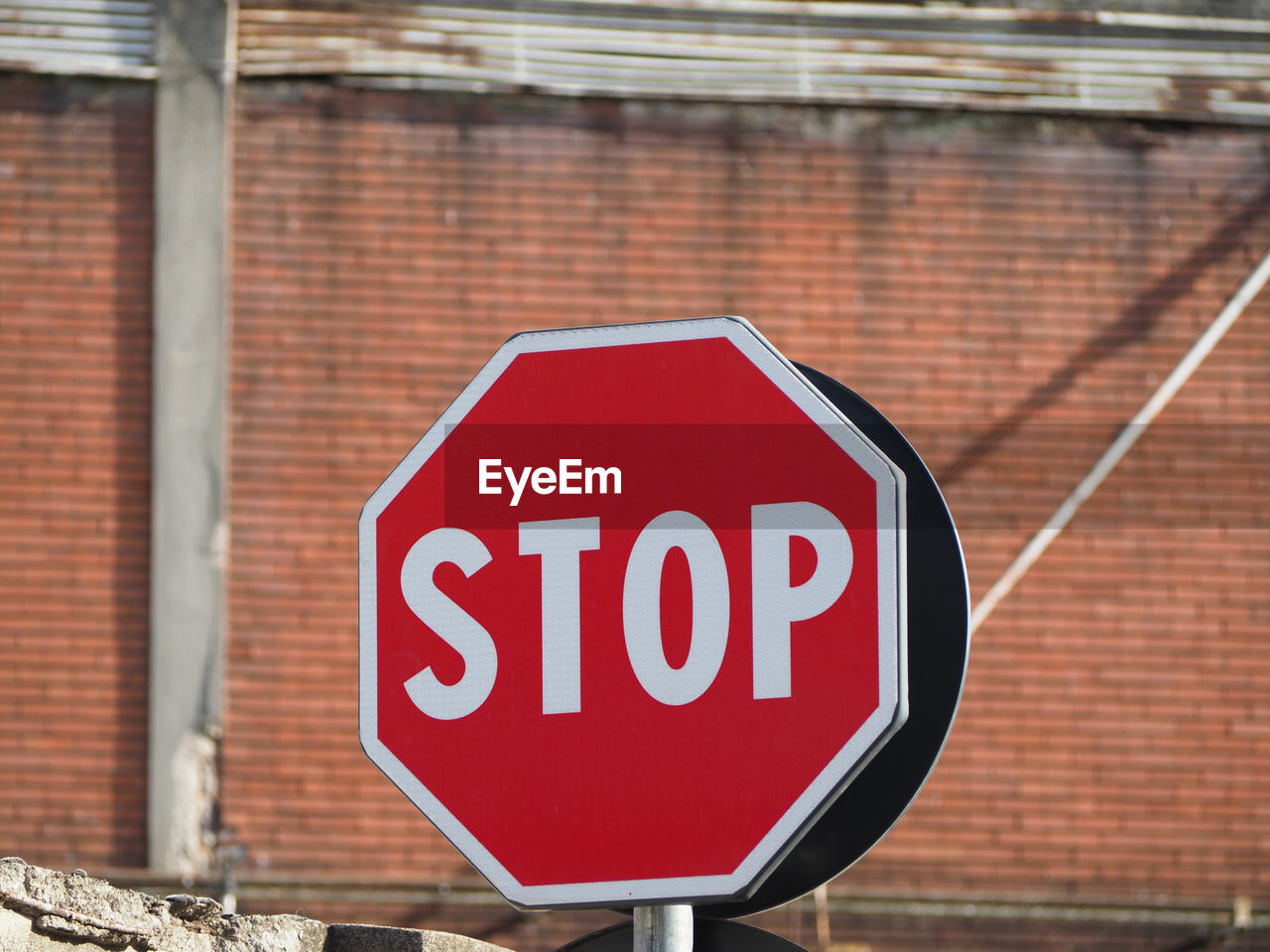 low angle view of road sign on wall