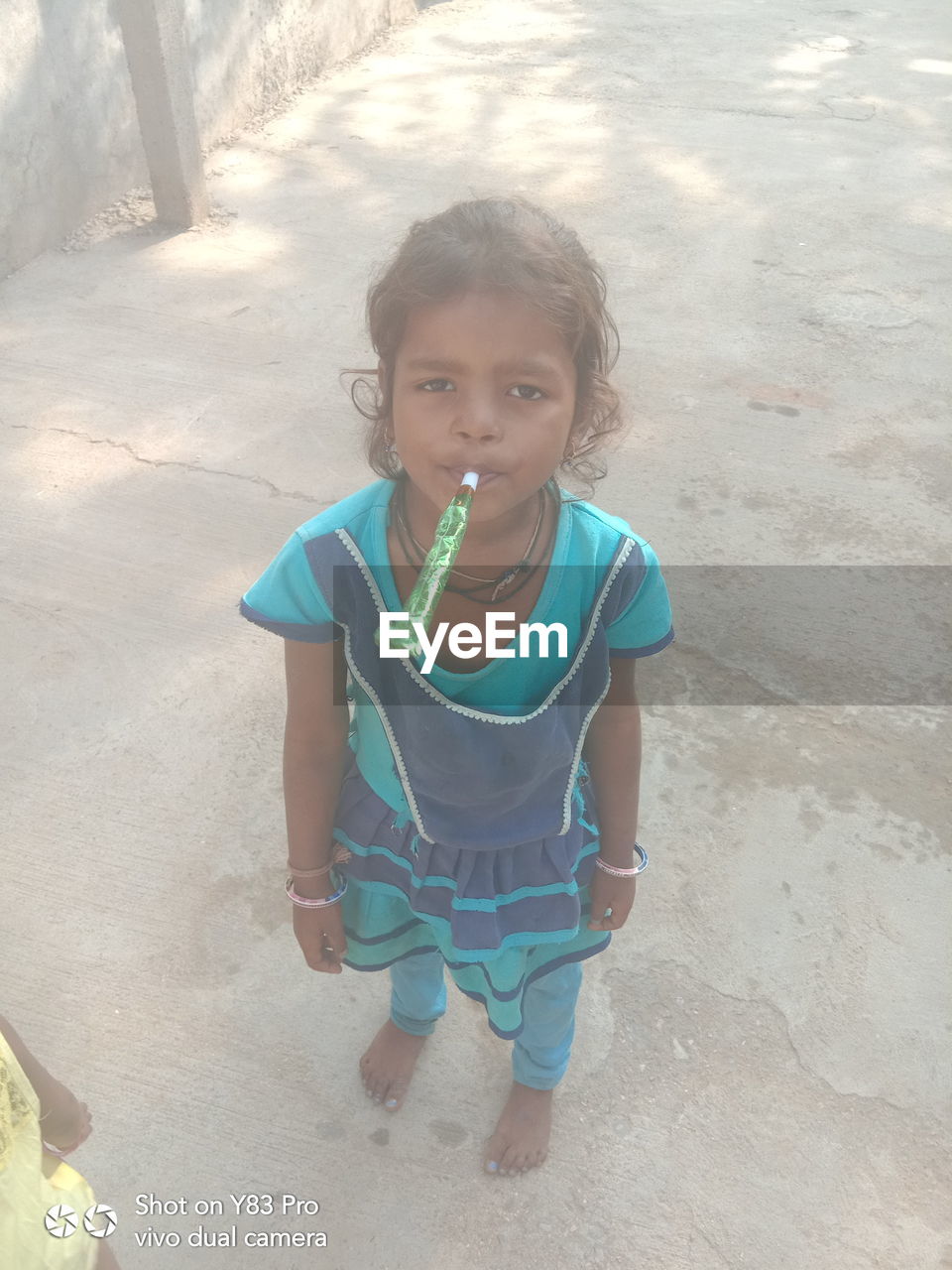 HIGH ANGLE PORTRAIT OF GIRL STANDING