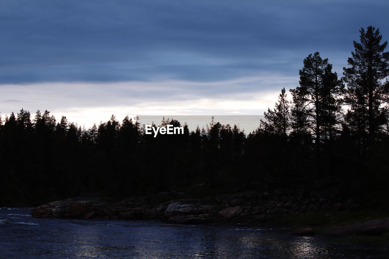 SILHOUETTE TREES BY LAKE AGAINST SKY DURING SUNSET