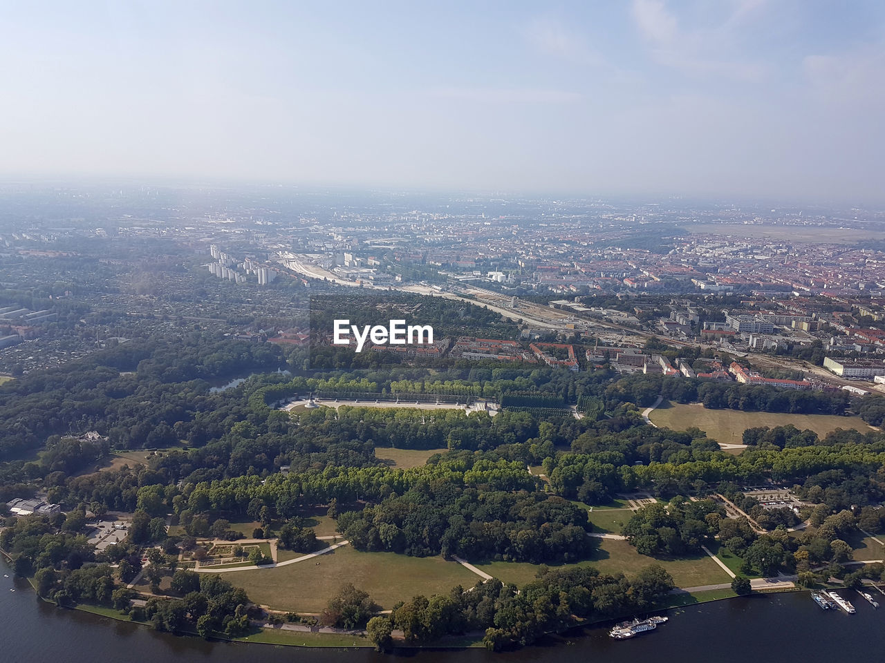 HIGH ANGLE VIEW OF RIVER AMIDST BUILDINGS IN CITY