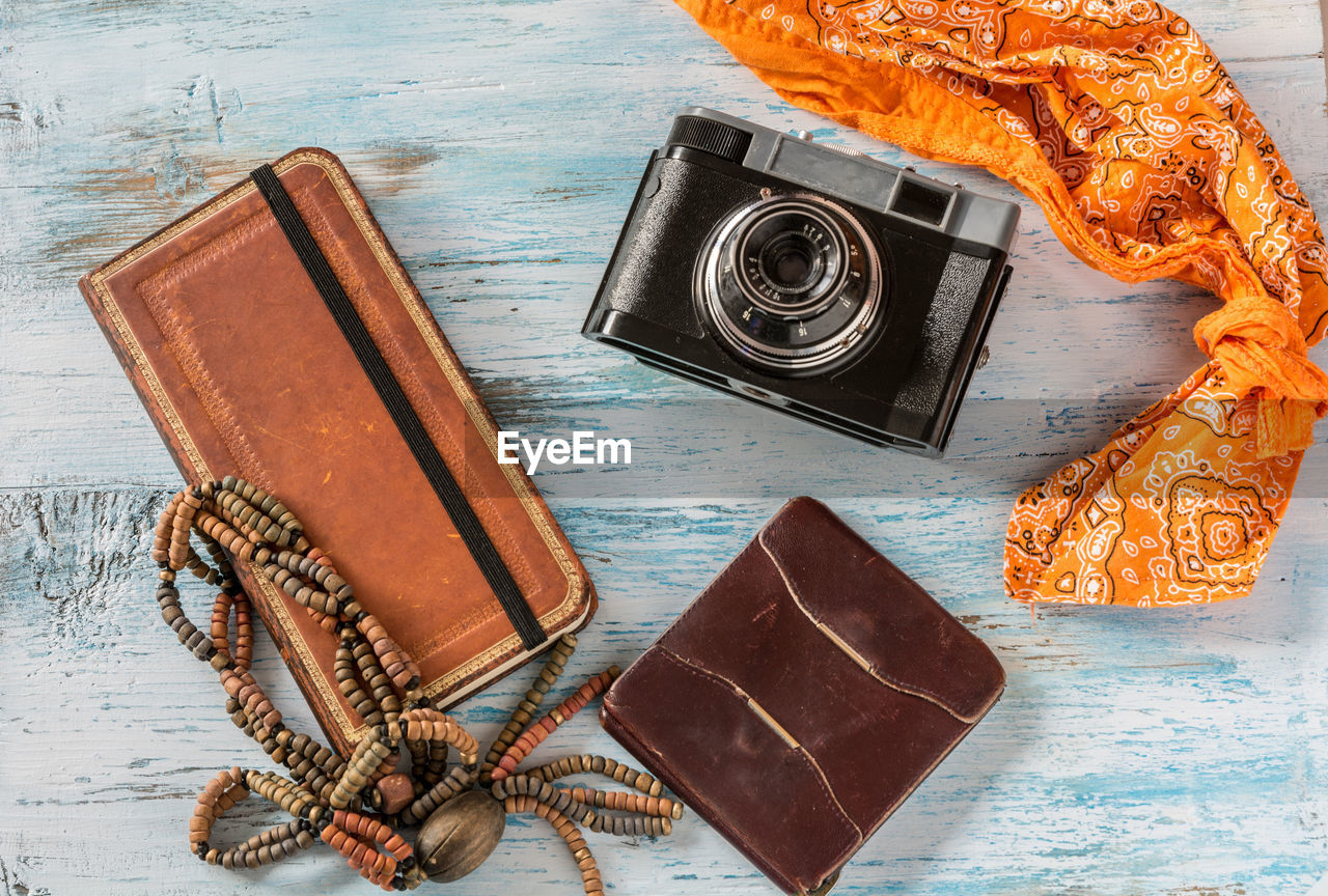 Close-up high angle view of wallets and camera