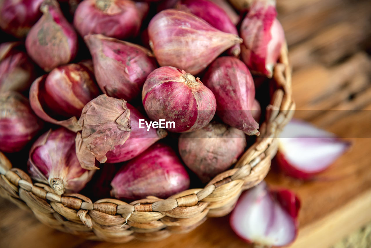 Close-up fresh shallots in a basket on the table