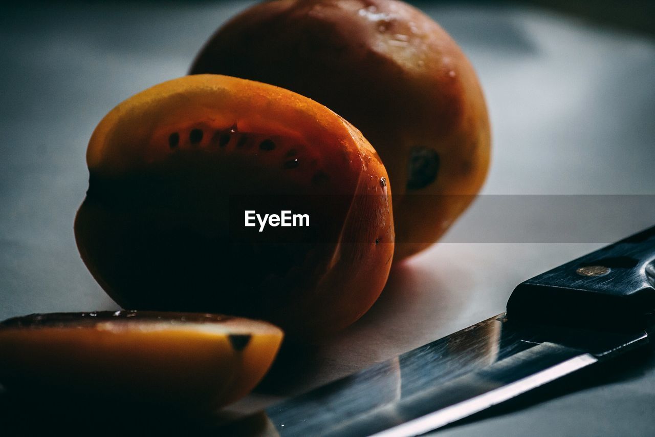 CLOSE-UP OF ORANGE SLICES ON TABLE