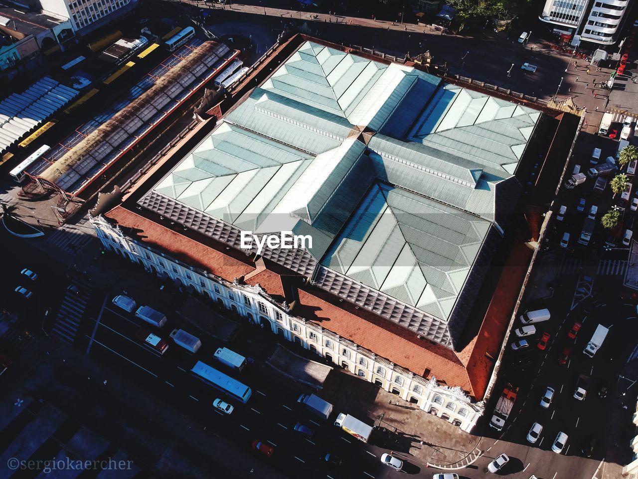 HIGH ANGLE VIEW OF MODERN BUILDINGS BY ROAD IN CITY