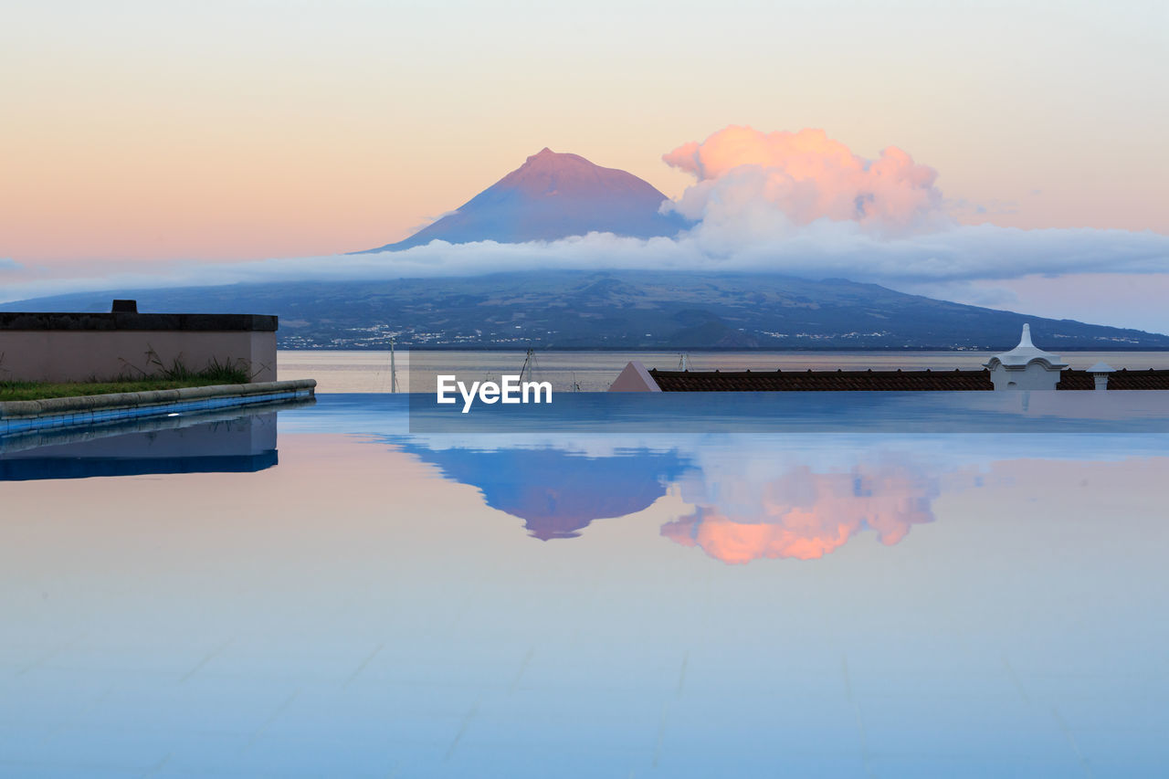 Scenic view of swimming pool against sky during sunset