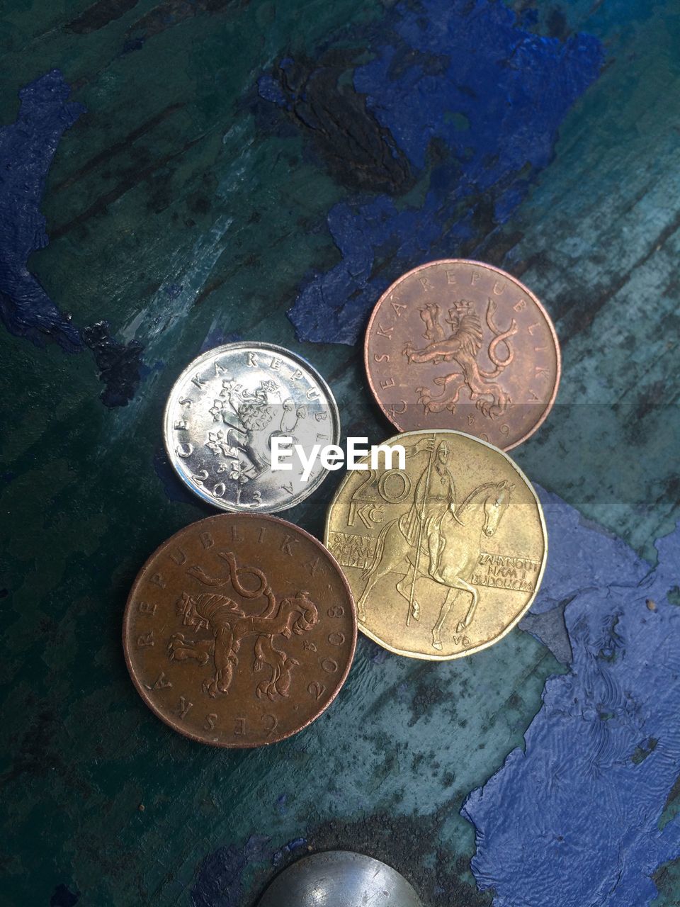 HIGH ANGLE VIEW OF COINS ON WHITE SURFACE