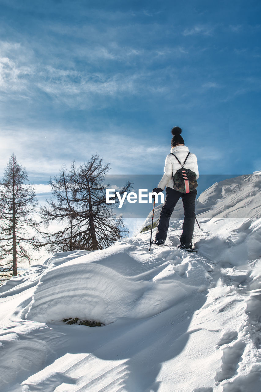 A woman on a snowshoeing trip on a sunny day