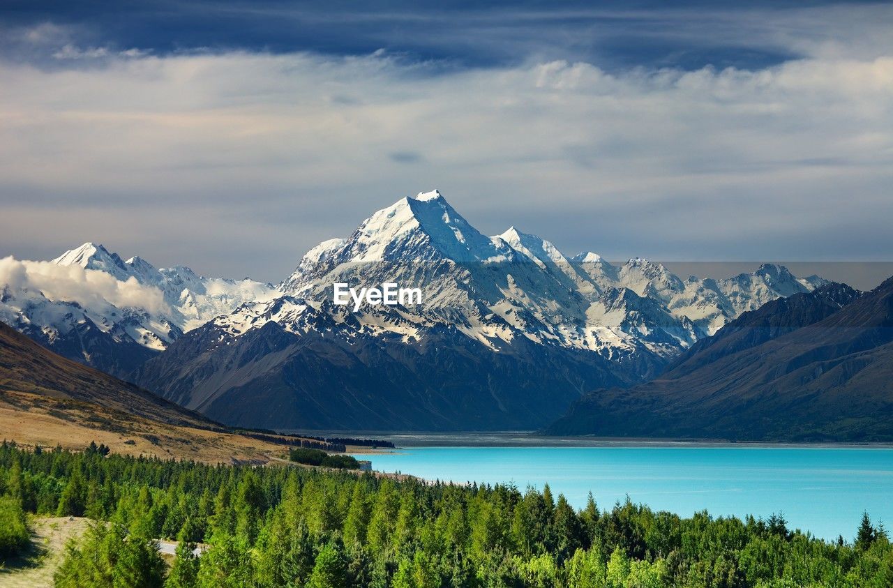 scenic view of lake and mountains against sky