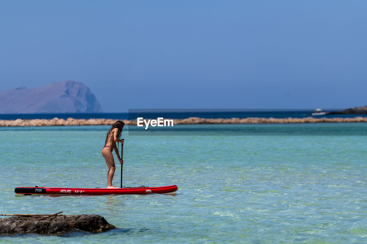 PERSON ON SEA AGAINST SKY