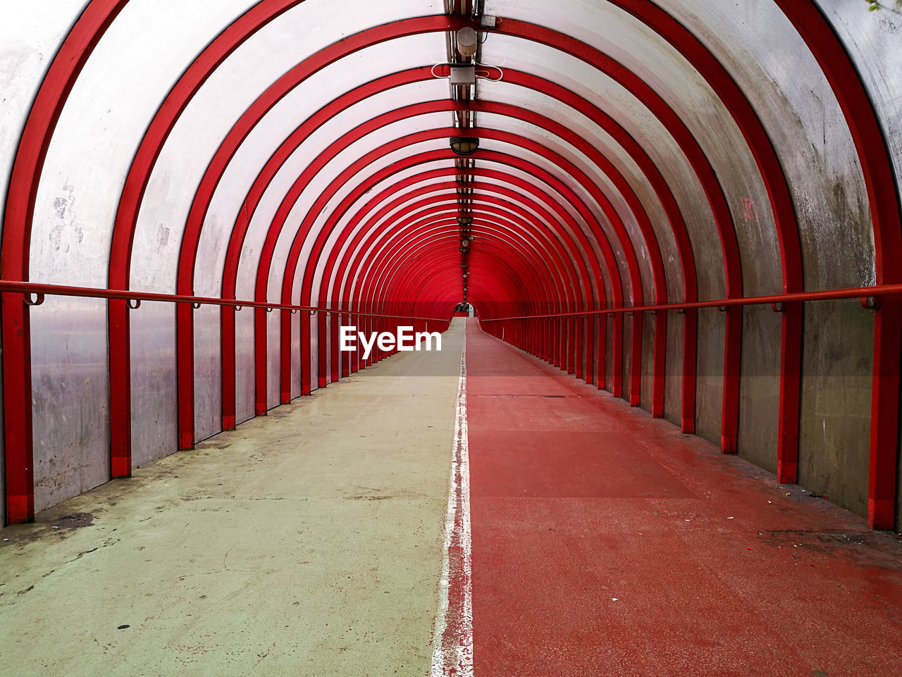 Empty red covered footbridge