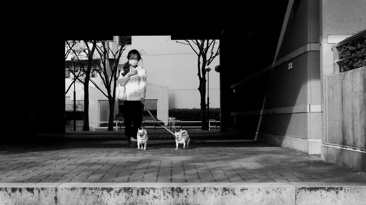 WOMAN STANDING ON FOOTBRIDGE