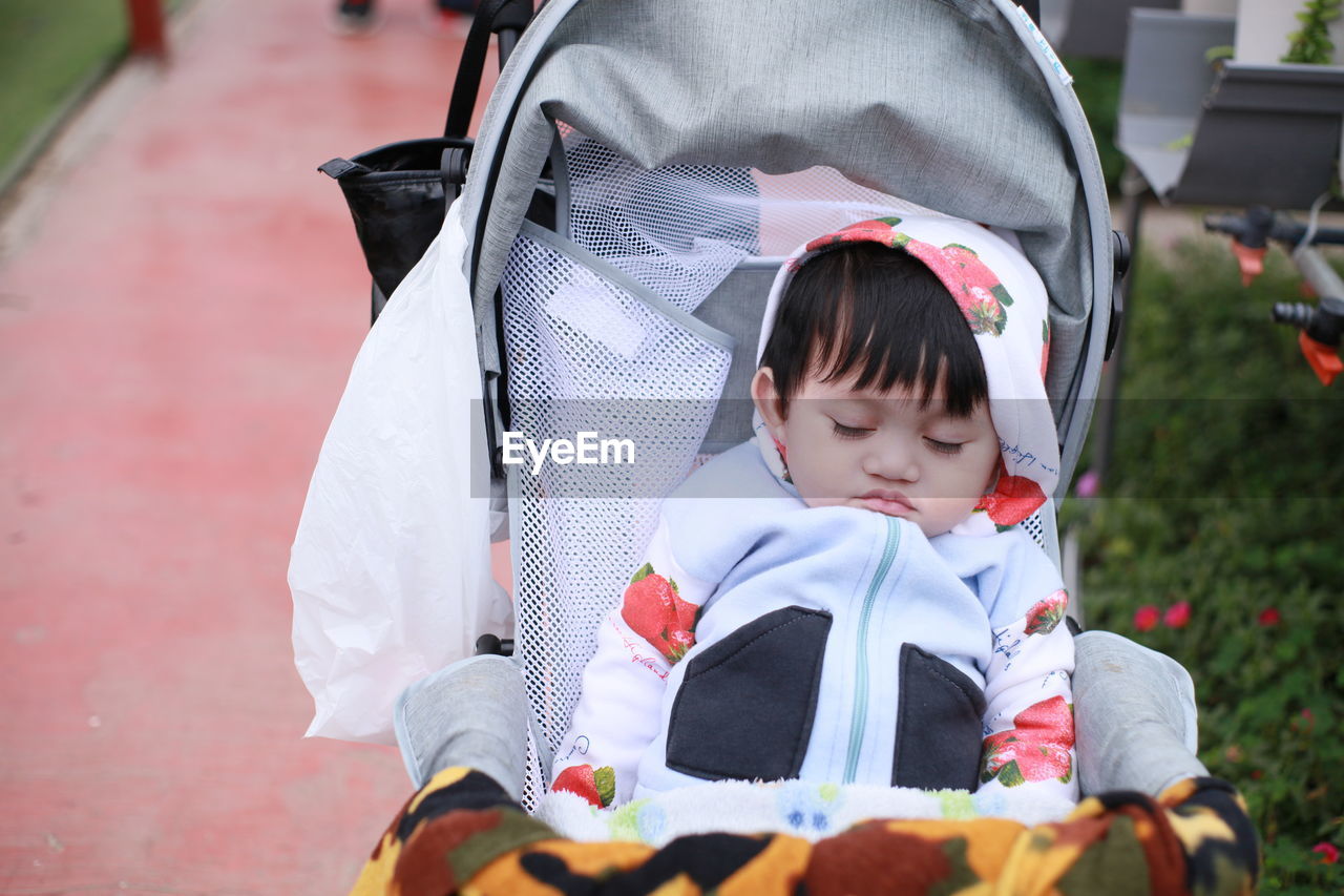 Cute baby boy sleeping in stroller