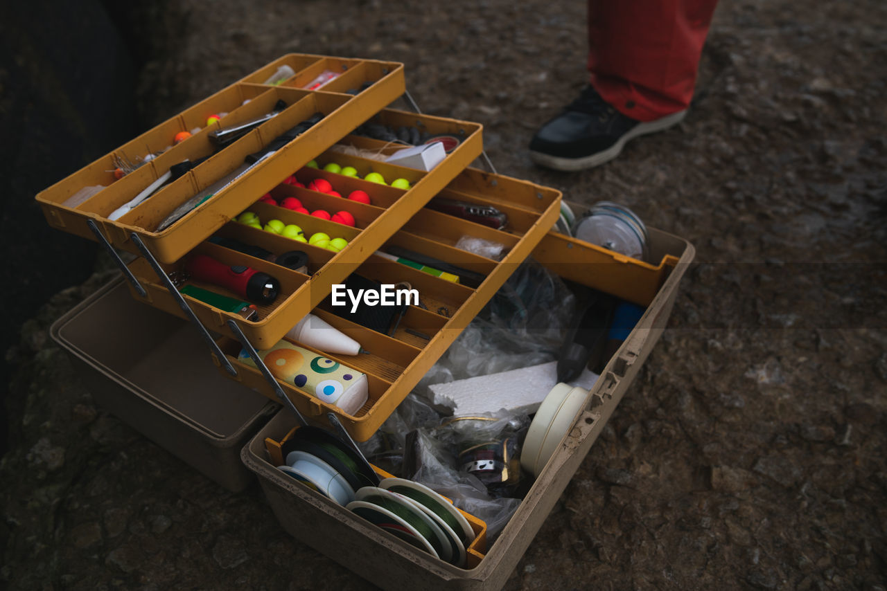 HIGH ANGLE VIEW OF STUFFED TOY IN BOX ON STONE