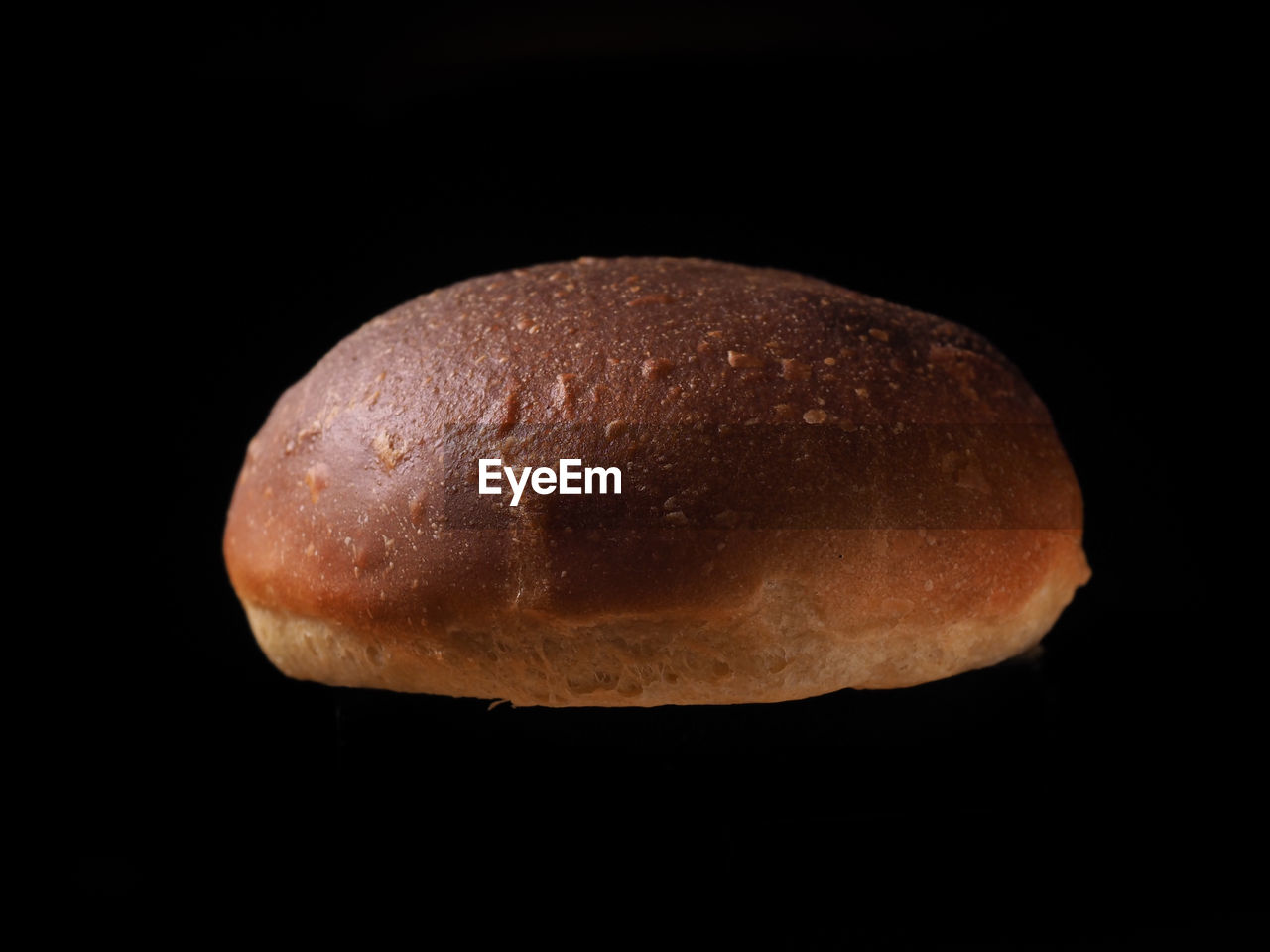 CLOSE-UP OF BREAD AGAINST BLACK BACKGROUND