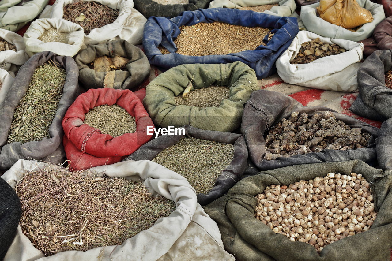 0111 sacks containing seeds-grains-herbs placed on the ground. sunday market-hotan-xinjiang-china.