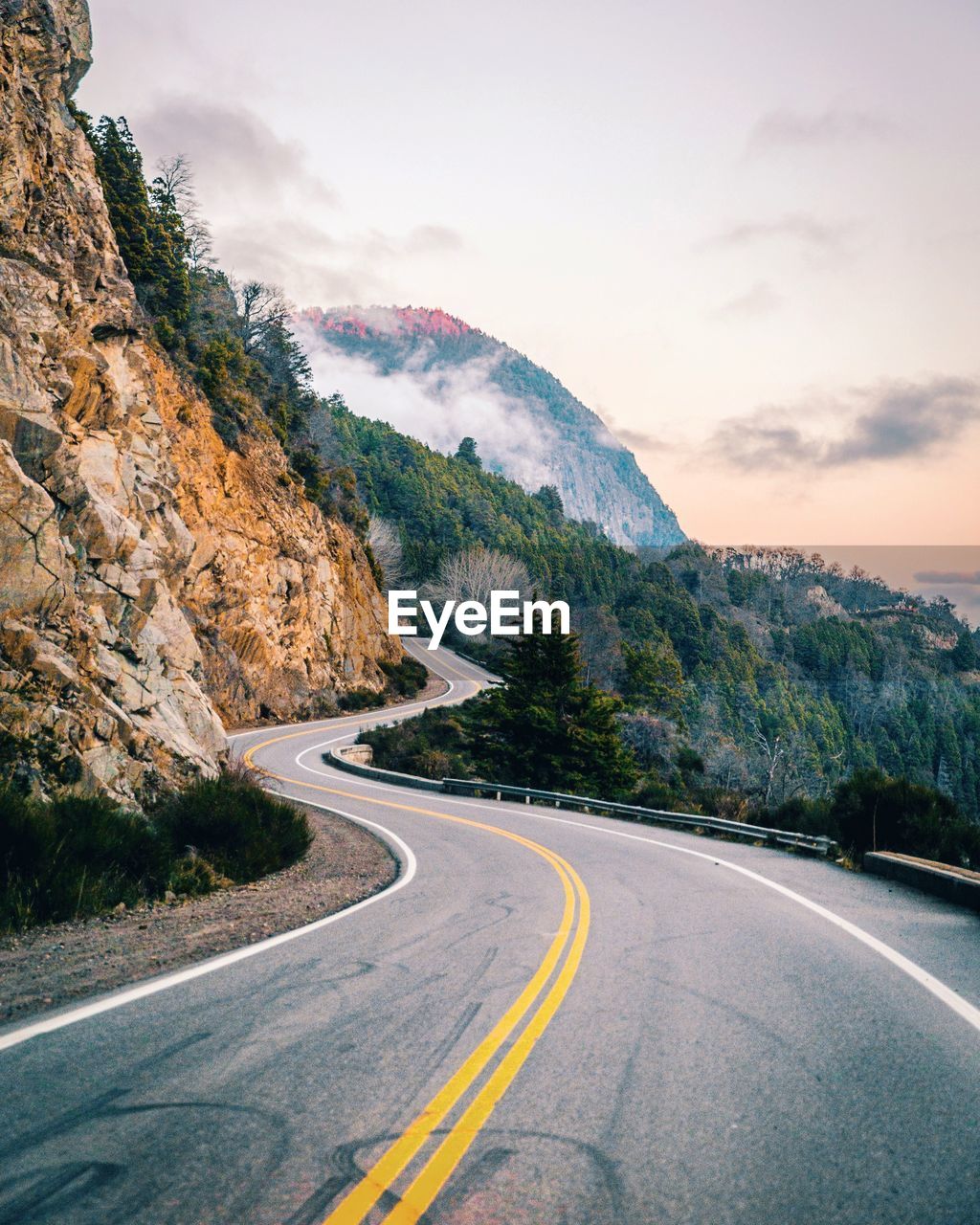 Road by mountains against sky