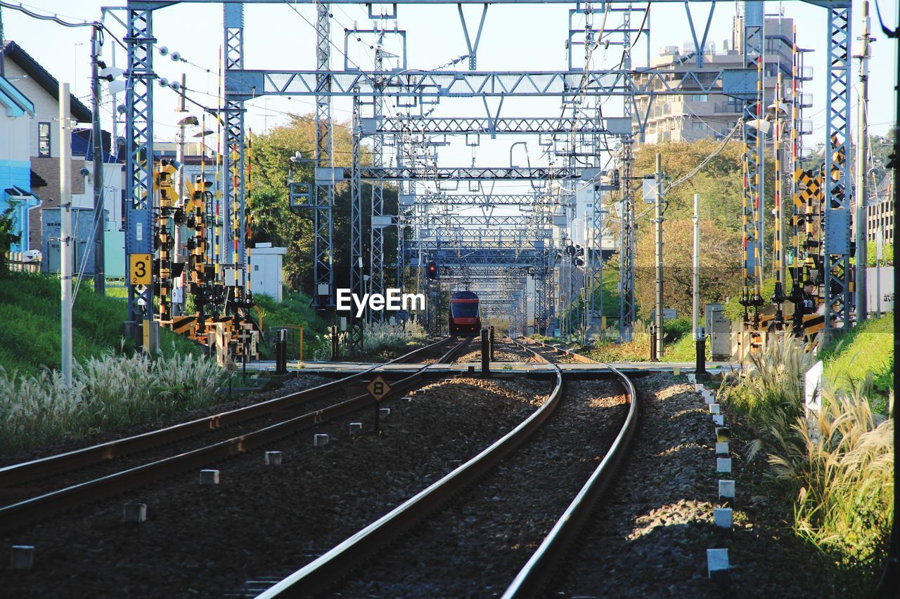 Railroad tracks by electricity pylon