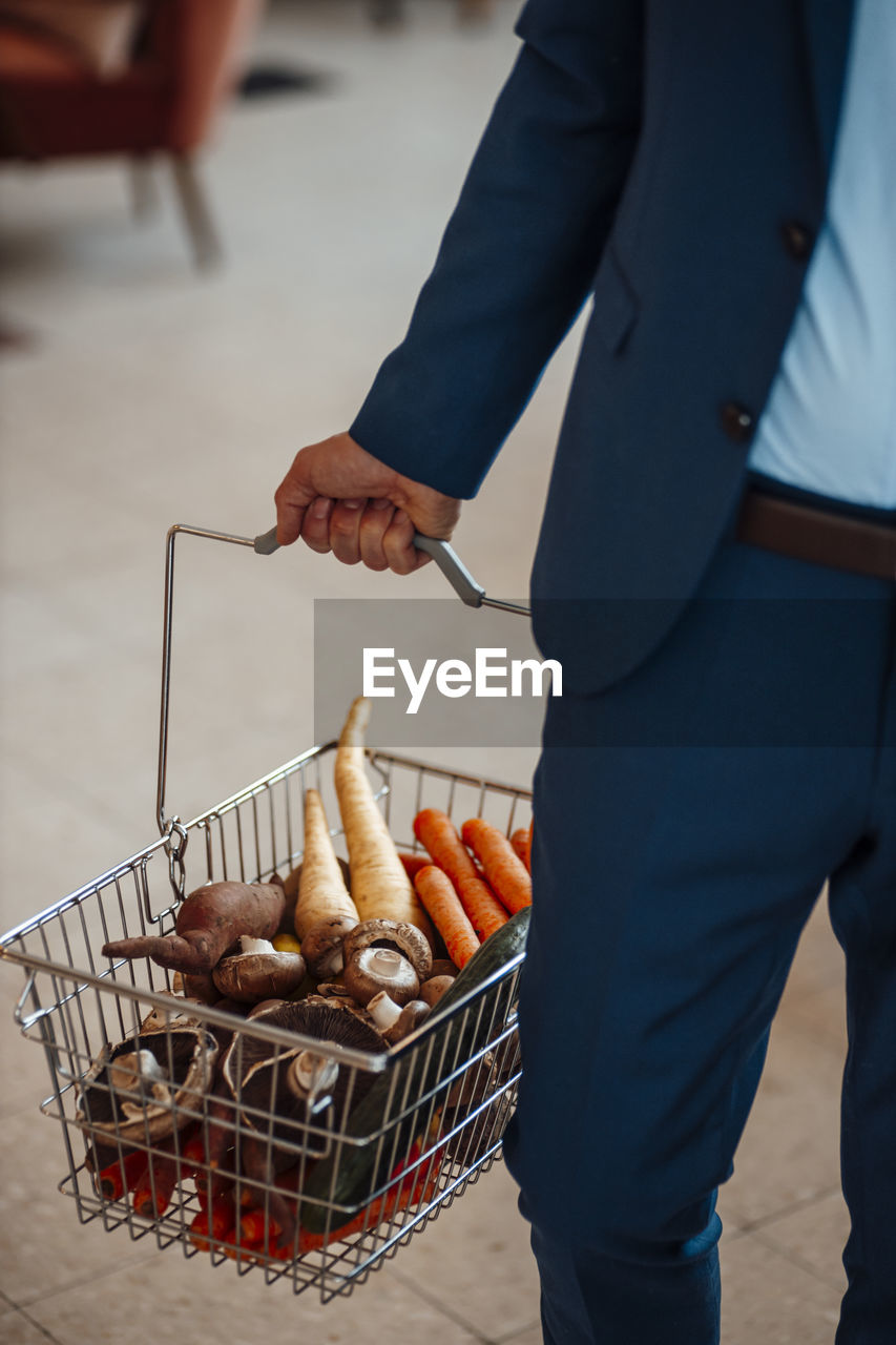 Mature businessman with basket of vegetables