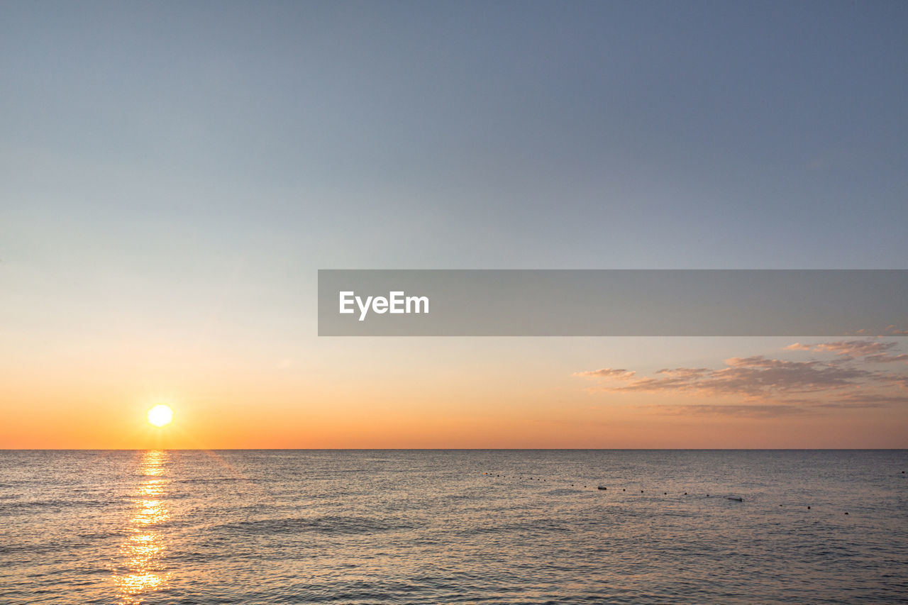 Sunrise on the sea with reflection on the water