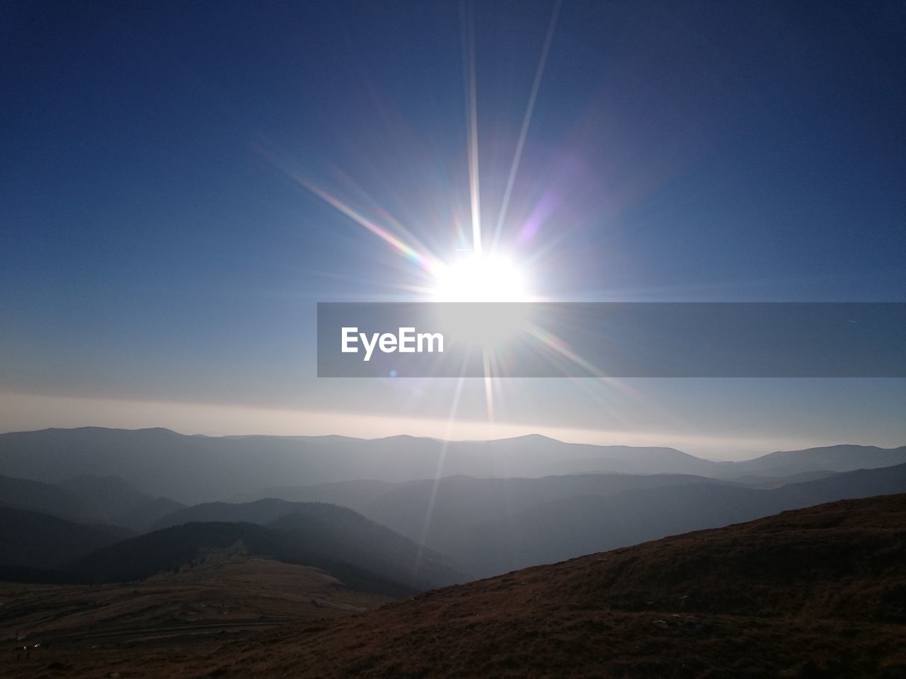 SCENIC VIEW OF MOUNTAINS AGAINST SKY AT SUNSET