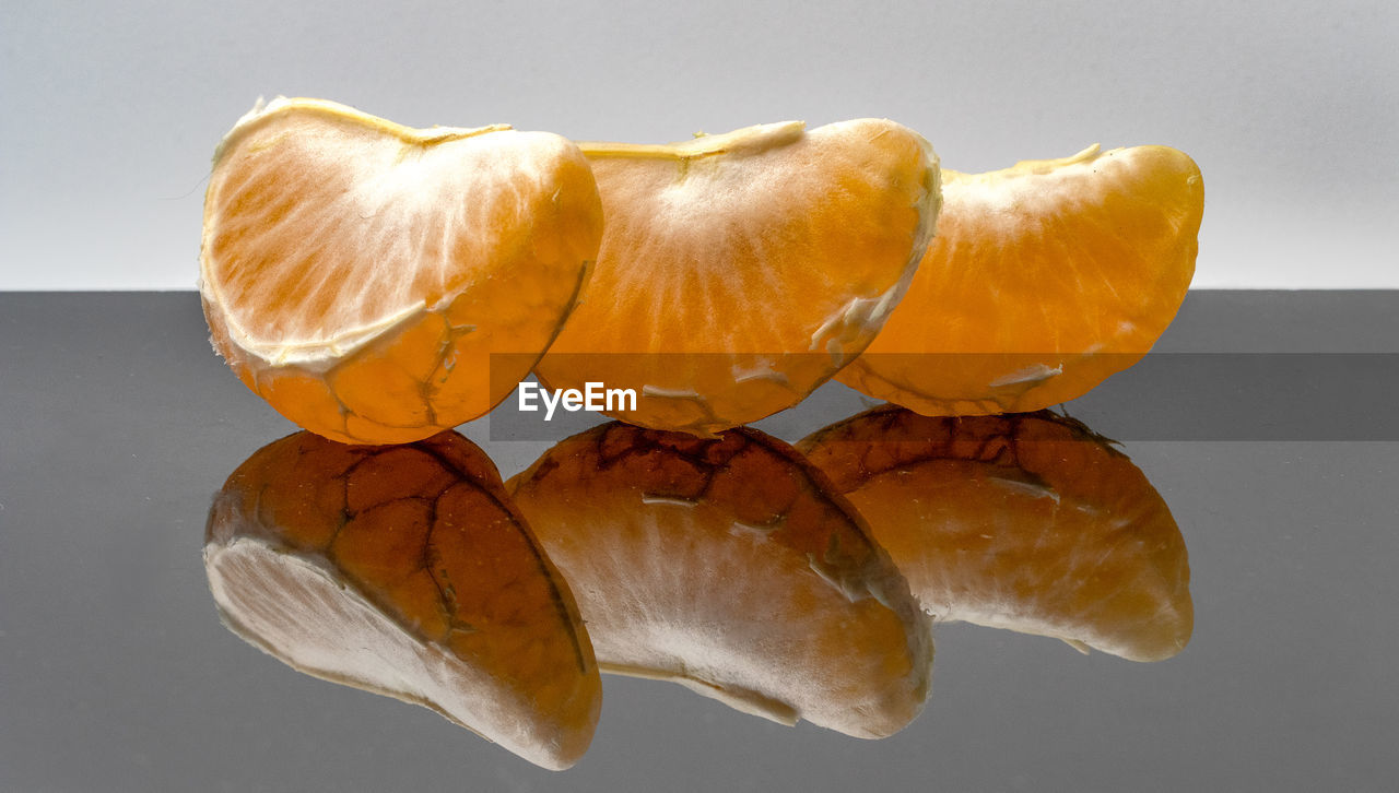 CLOSE-UP OF ORANGE ON TABLE