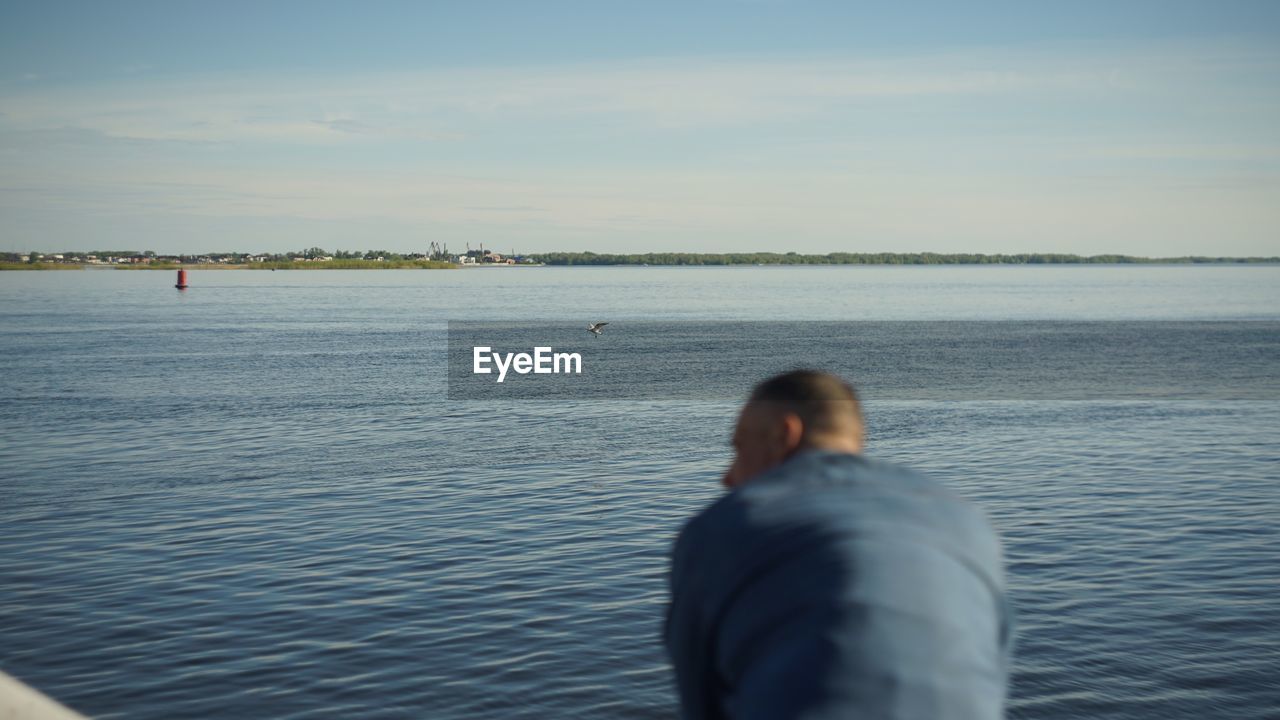 REAR VIEW OF MAN IN SEA