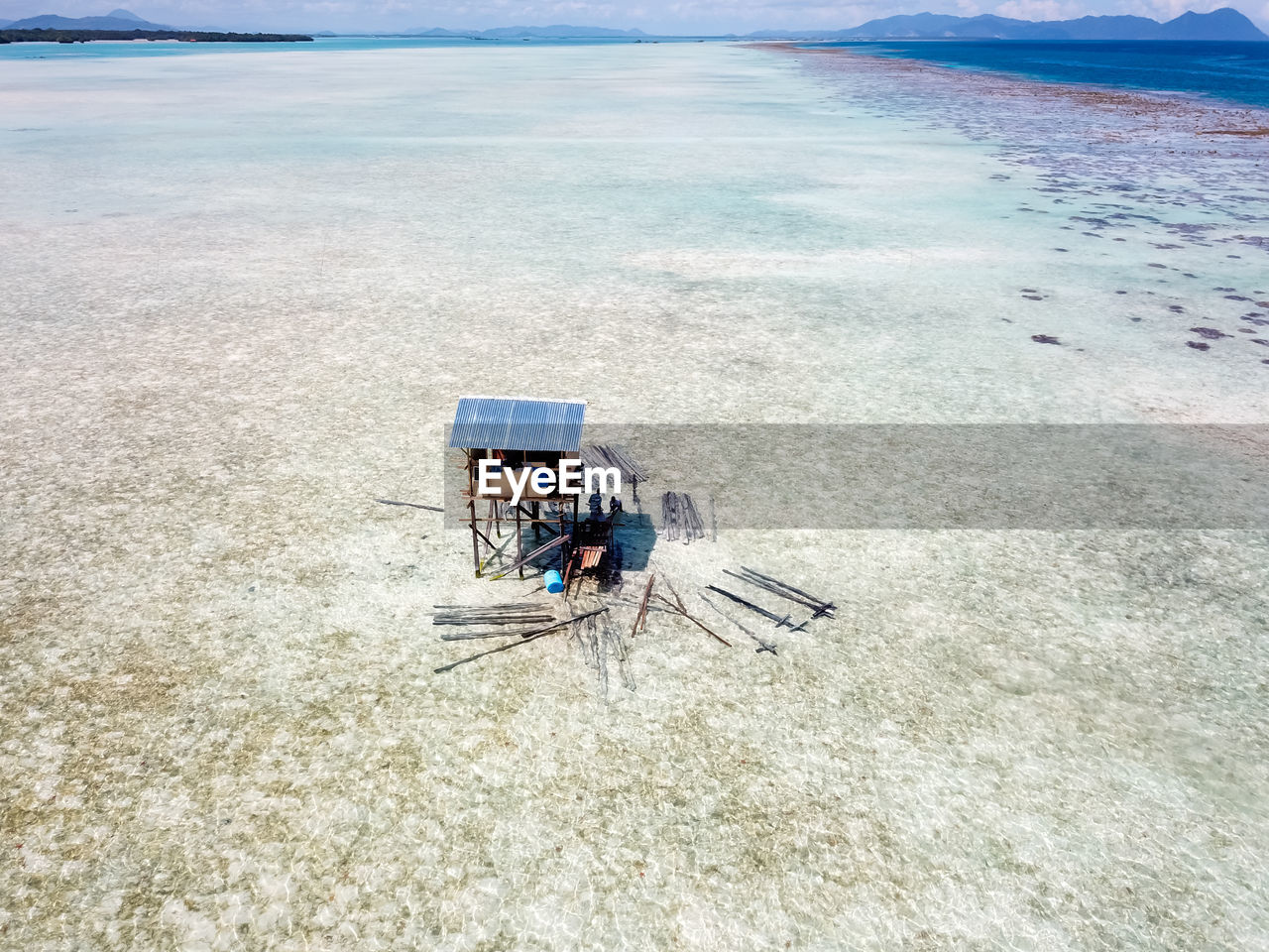 High angle view of construction of a small hut sitting on beach