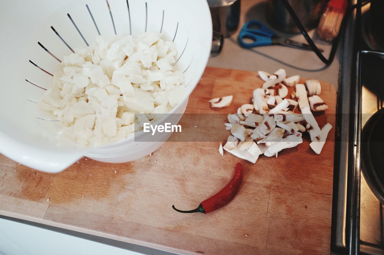 Chopped mozzarella in colander on kitchen counter