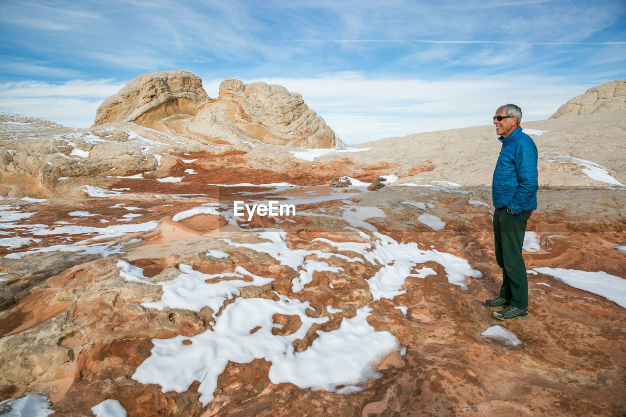 Man contemplates winter at white pocket /vermilion cliffs, northern az