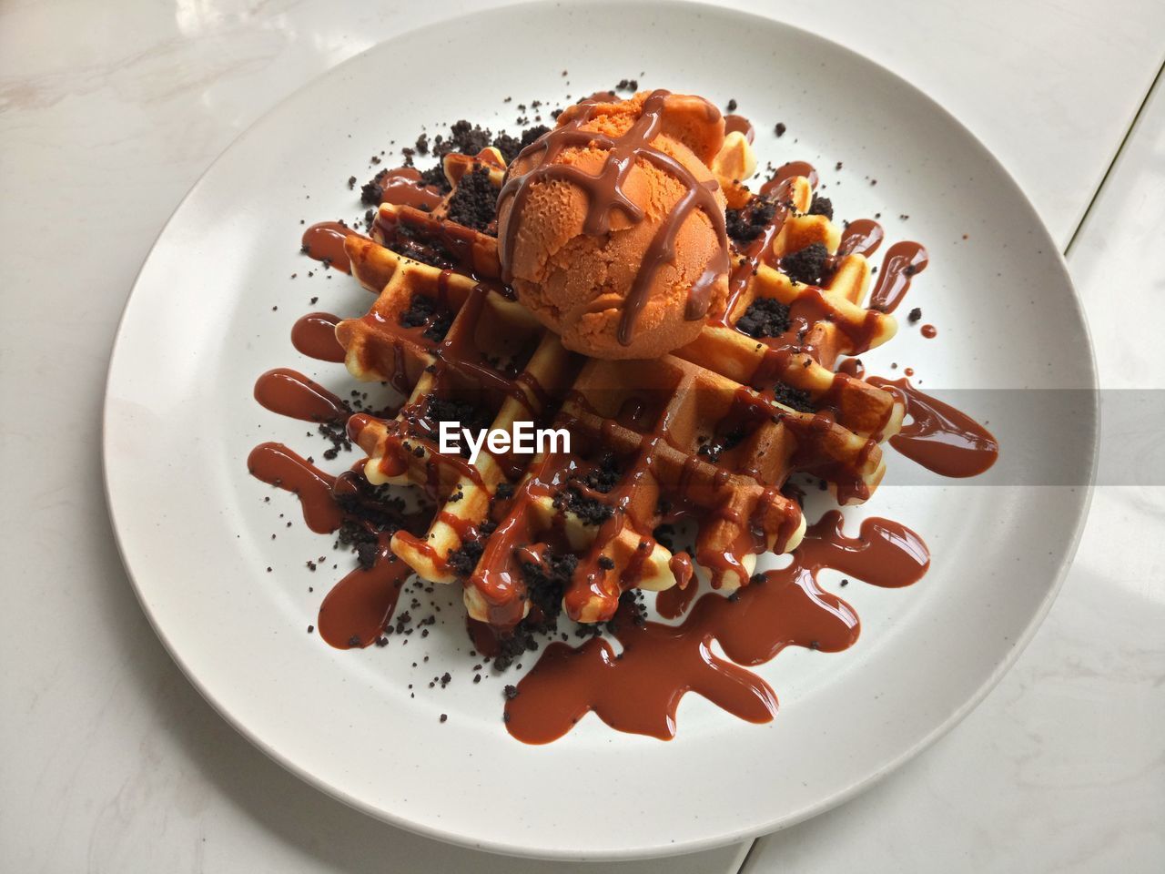 High angle view of waffle with ice cream in plate on table