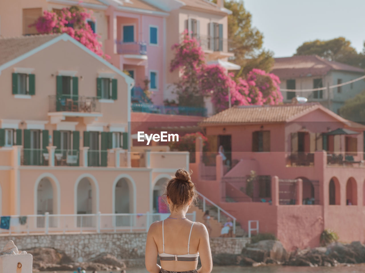 Rear view of woman standing against colorful buildings