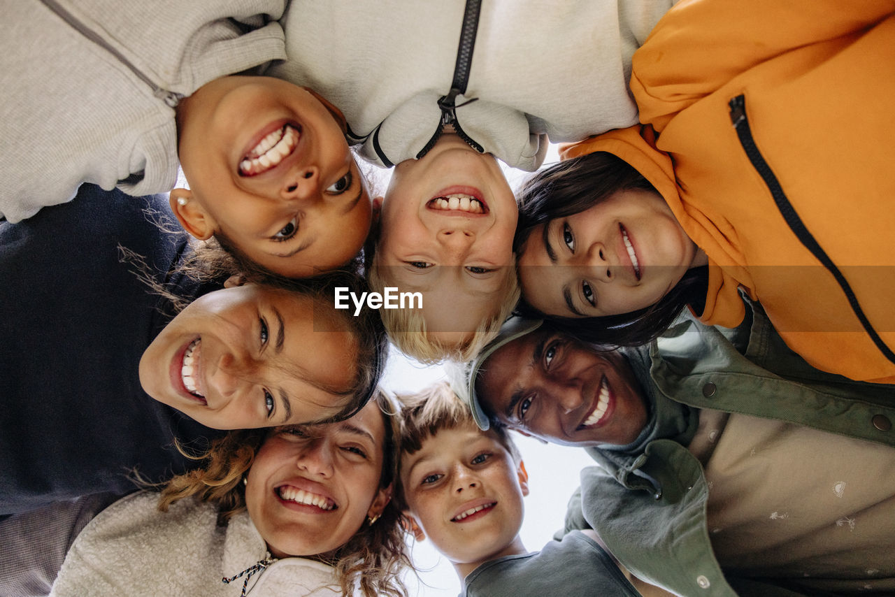 Directly below shot of children huddling with counselors