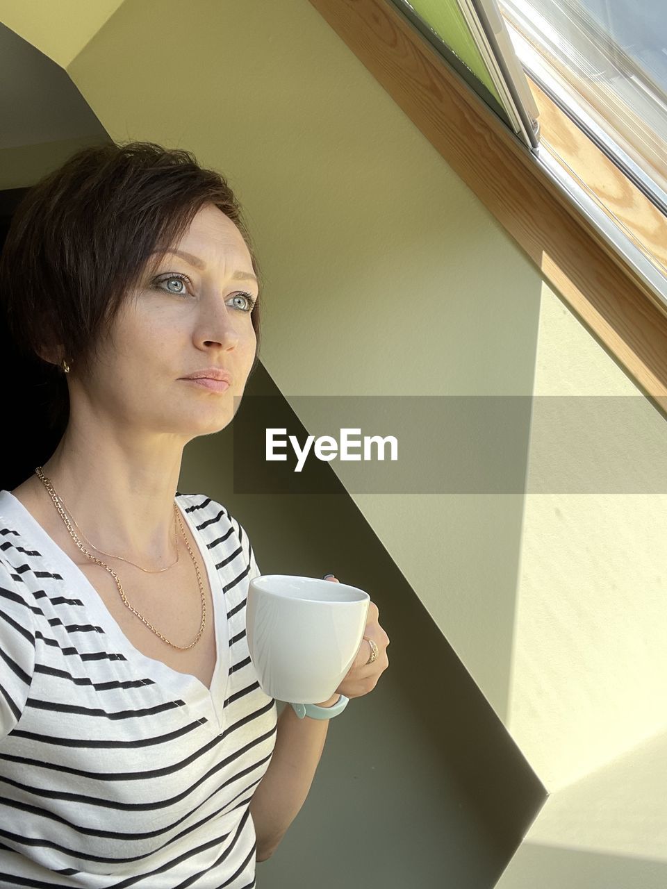 Portrait of young woman drinking coffee