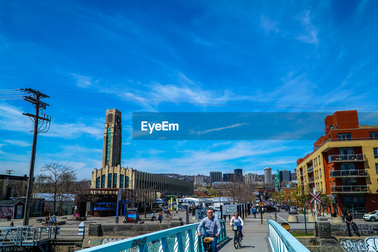 PANORAMIC VIEW OF CITY AGAINST BLUE SKY