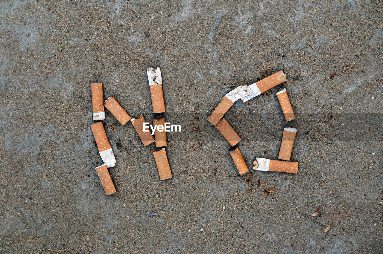 High angle view of cigarette on road