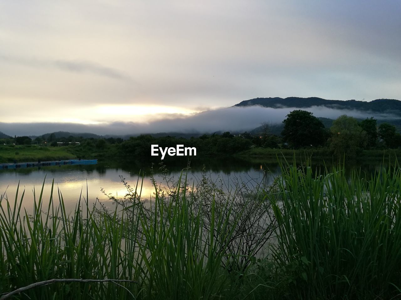 Scenic view of lake against cloudy sky