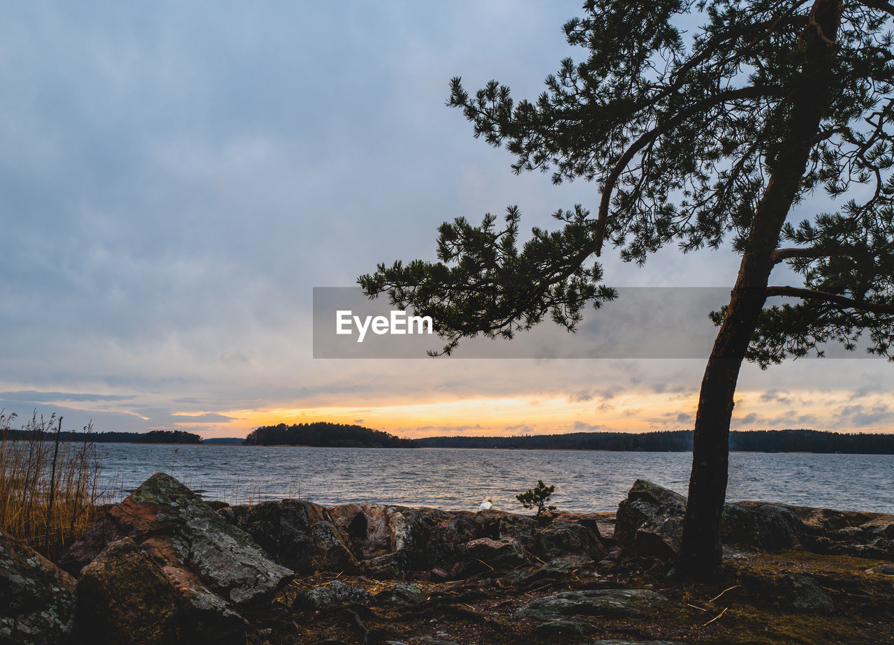 Scenic view to the sea against a sunset sky