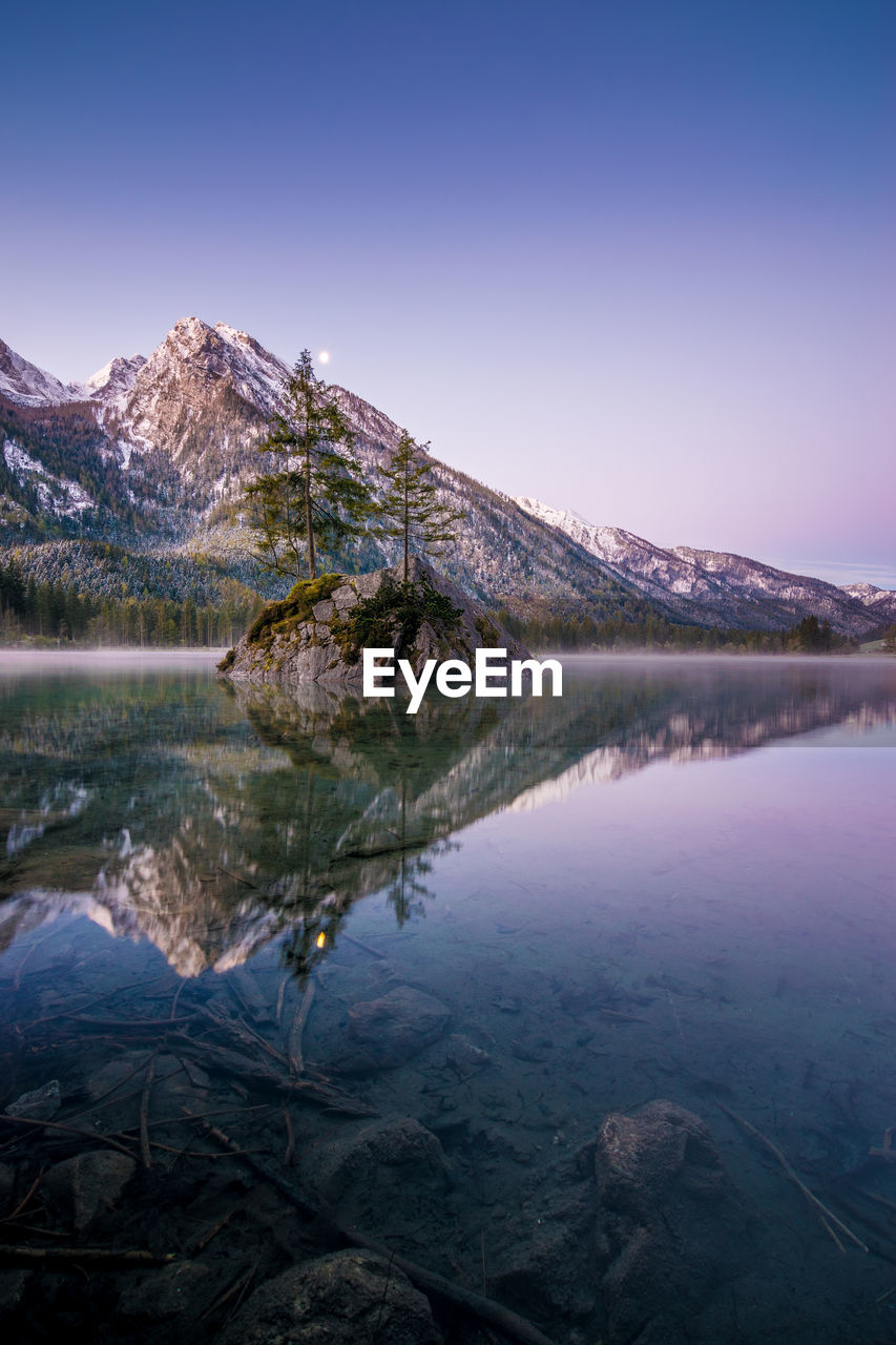 Scenic view of lake and mountains against clear sky