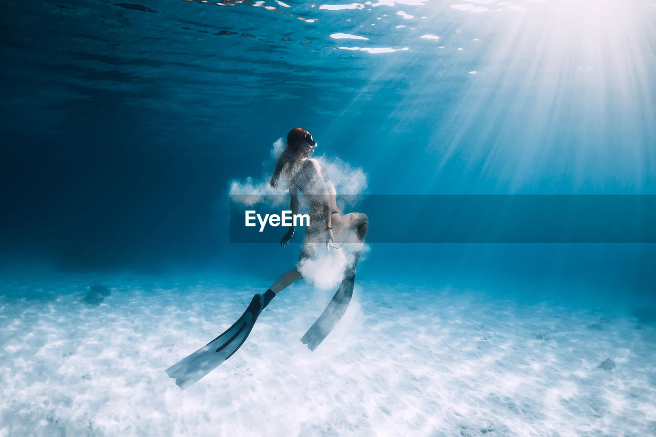 rear view of woman standing in swimming pool