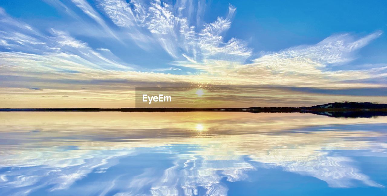 sky, water, reflection, cloud, scenics - nature, beauty in nature, nature, blue, horizon, tranquility, environment, landscape, sea, sunlight, sunset, tranquil scene, no people, dawn, ocean, wave, sun, outdoors, land, shore, travel destinations, travel, idyllic, dramatic sky, lagoon, cold temperature, cloudscape, beach
