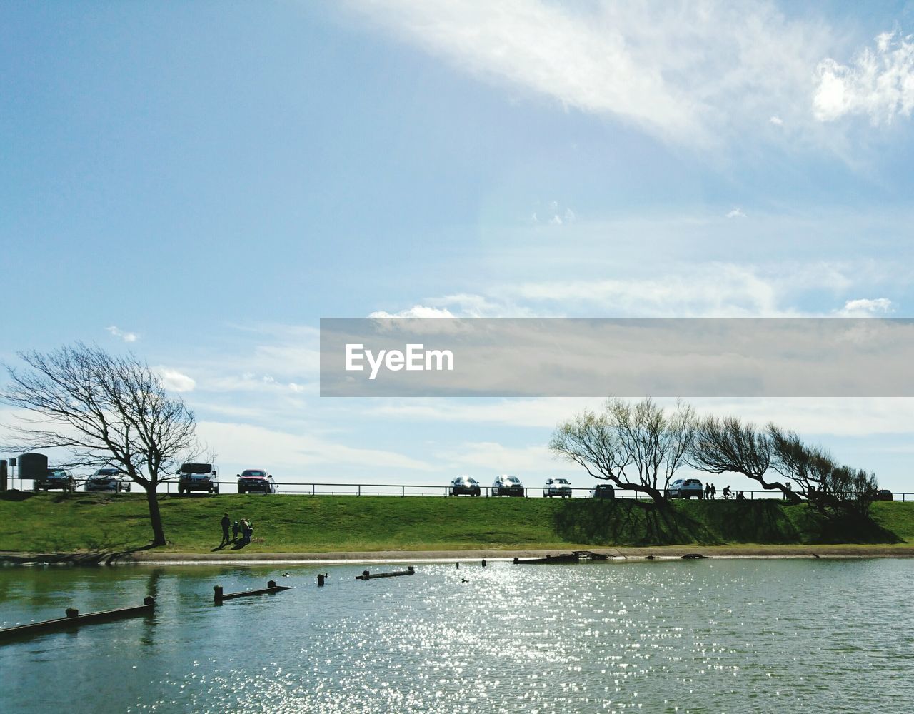 Scenic view of lake against cloudy sky