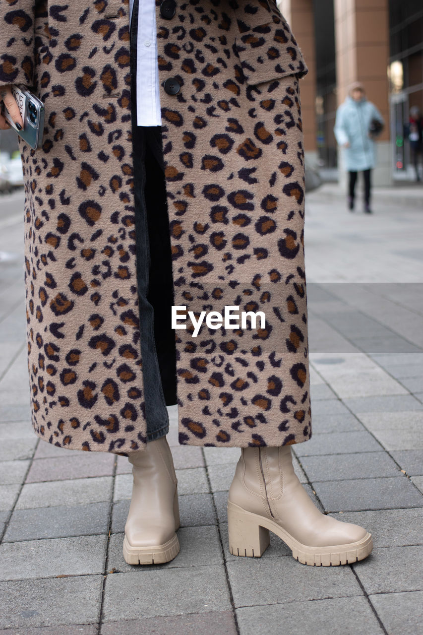 low section of woman standing on street