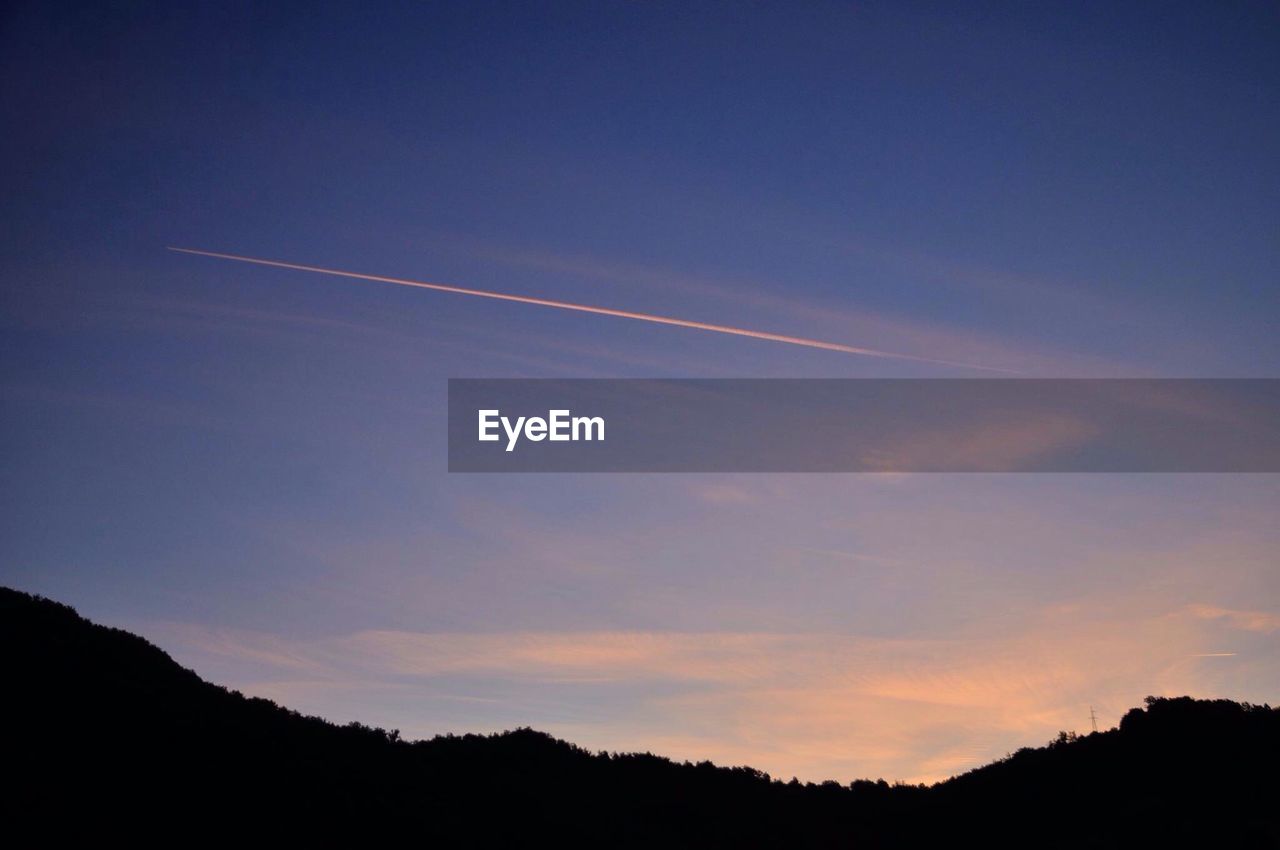 Scenic view of vapor trails in sky