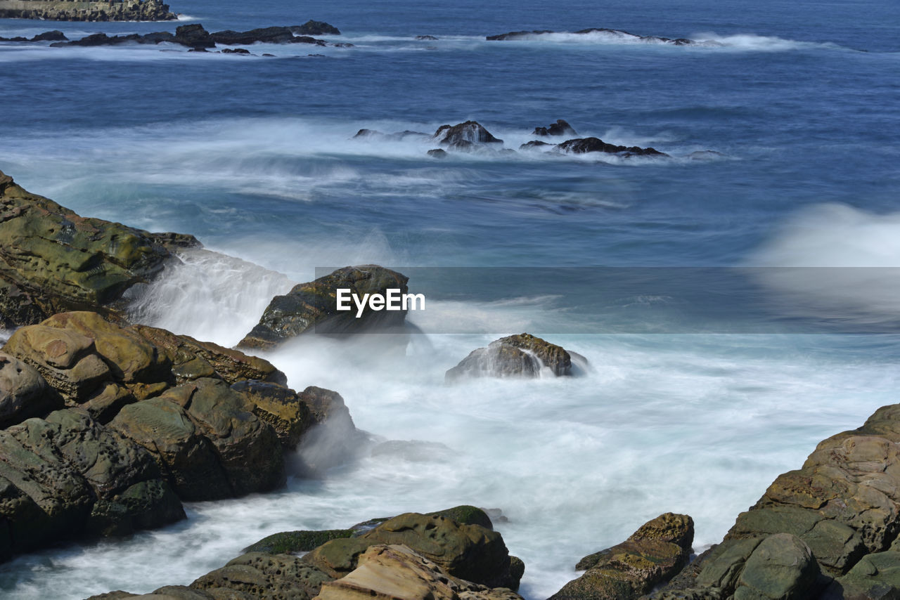 SCENIC VIEW OF SEA WAVES ROCKS