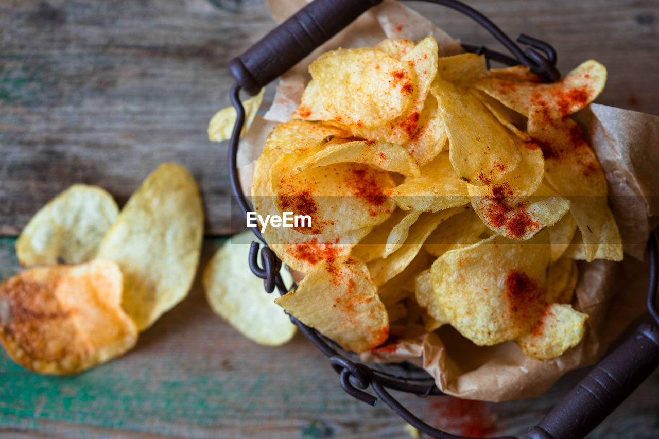 High angle view of fresh crunchy potato chips on table