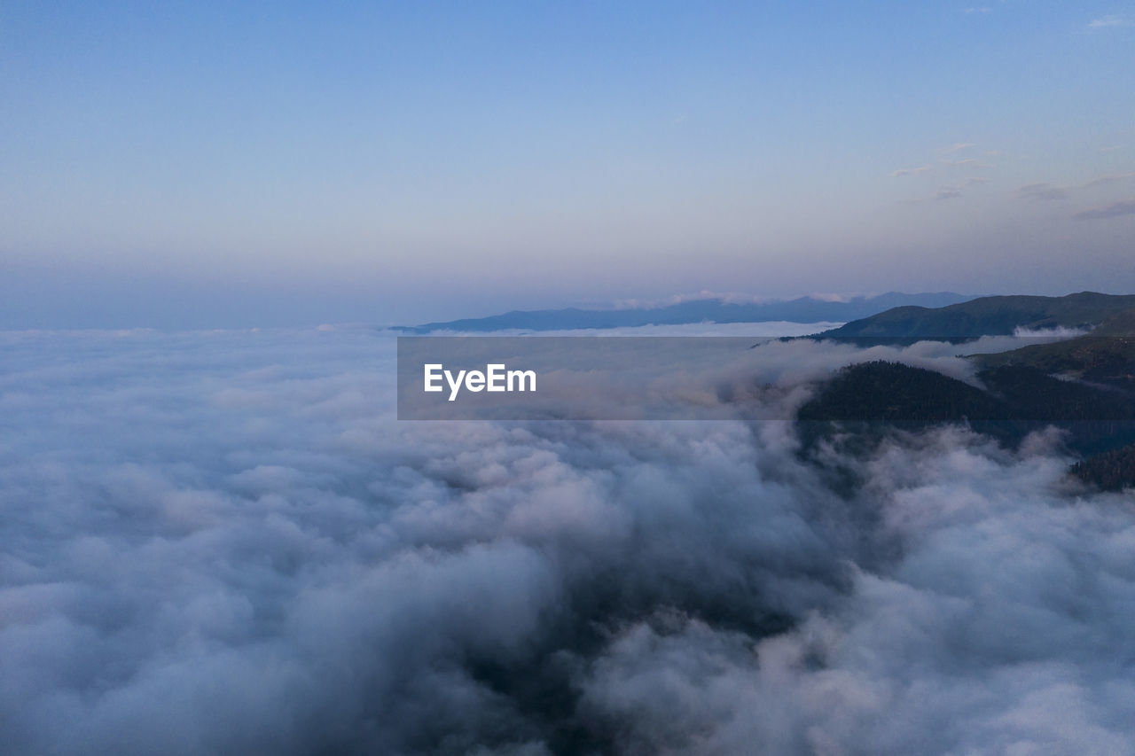 SCENIC VIEW OF CLOUDSCAPE OVER MOUNTAINS