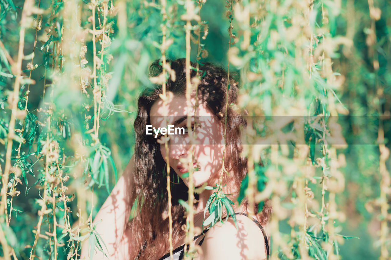 Young woman amidst plants