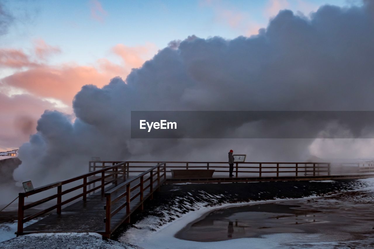 RAILING BY SEA AGAINST SKY DURING WINTER