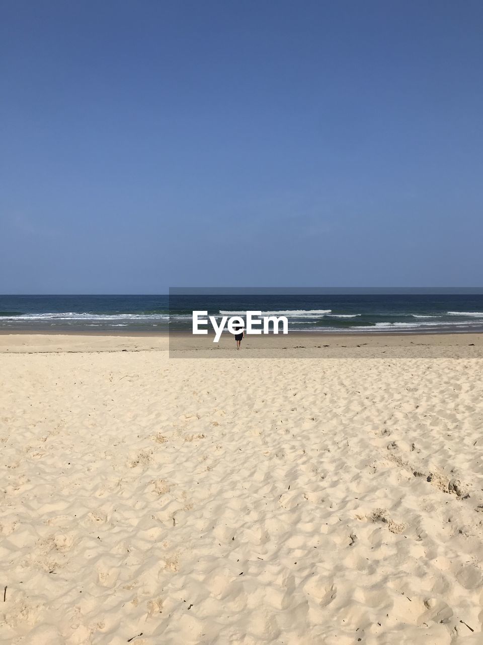 Scenic view of beach against clear sky